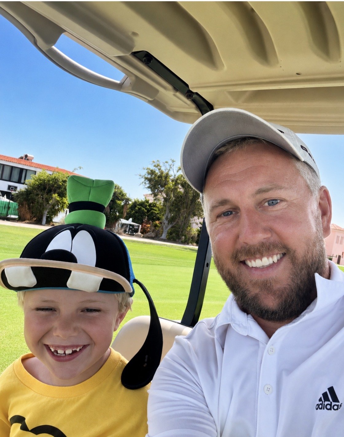 Lee Taylor and son on golf buggy, Tenerife